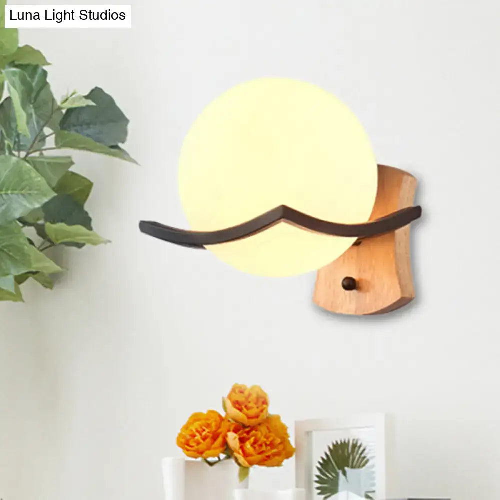 Wood and opal glass globe wall sconce with warm yellow lamp 110v-120v and dark brown mustache accent on wooden base
