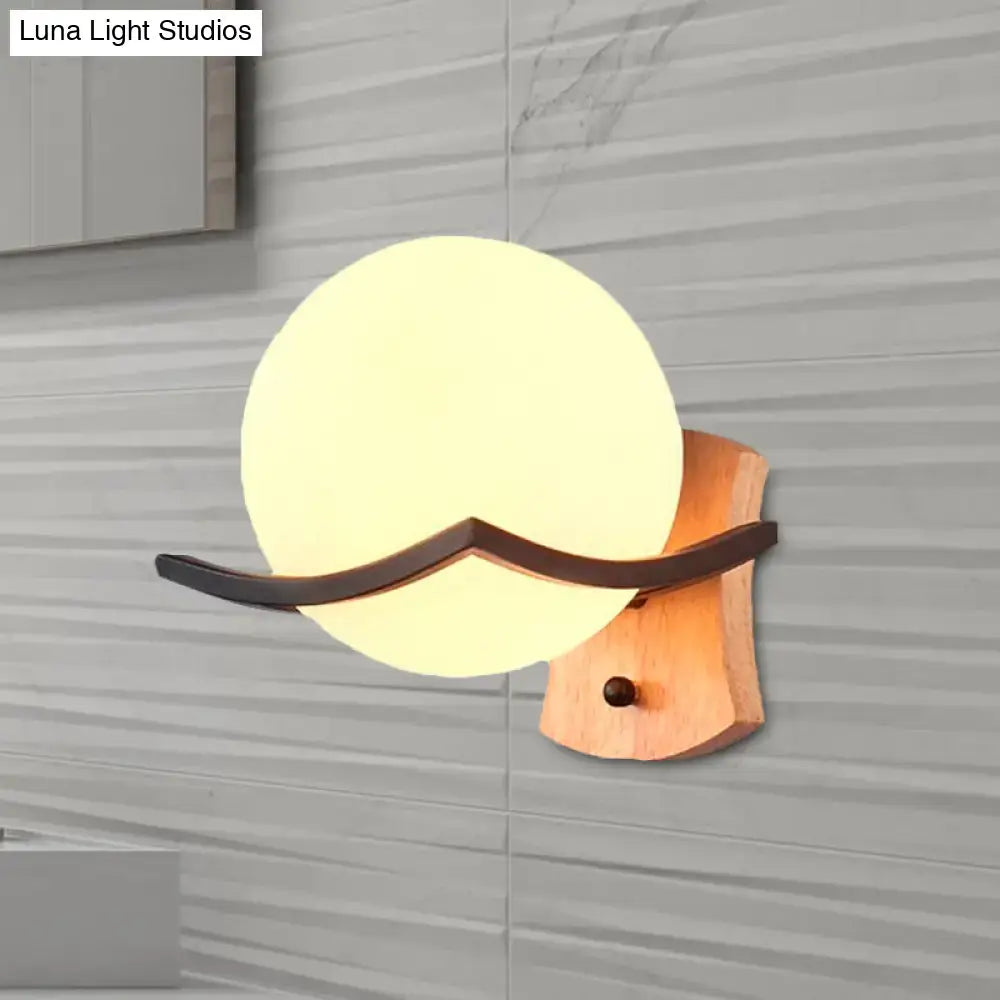 Warm-toned wood and opal glass globe wall sconce with dark metal accent for living room 110v-120v lighting