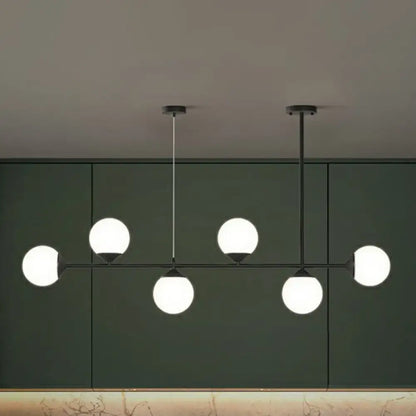 Modern black metal chandelier with five frosted opaline glass globe bulbs for minimalist dining room island lighting