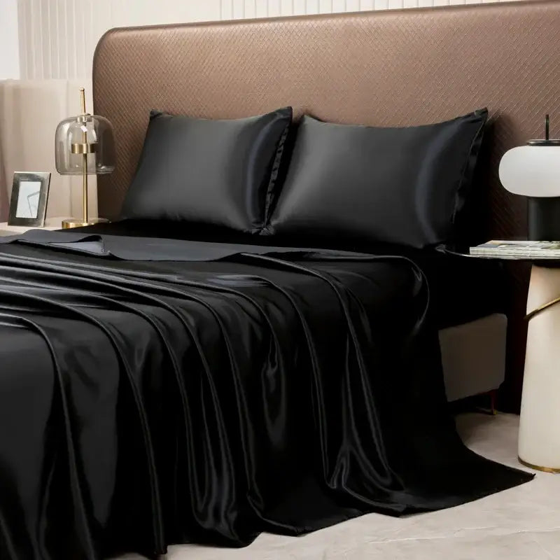 Black satin bedding set by decorbites with a smooth glossy finish featuring a flat sheet for luxurious comfort