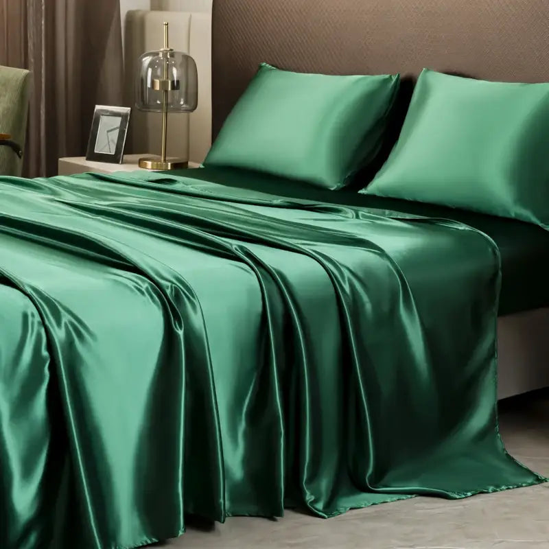 Emerald green satin bedding set with matching pillowcases featuring a flat sheet from decorbites™ opulent collection