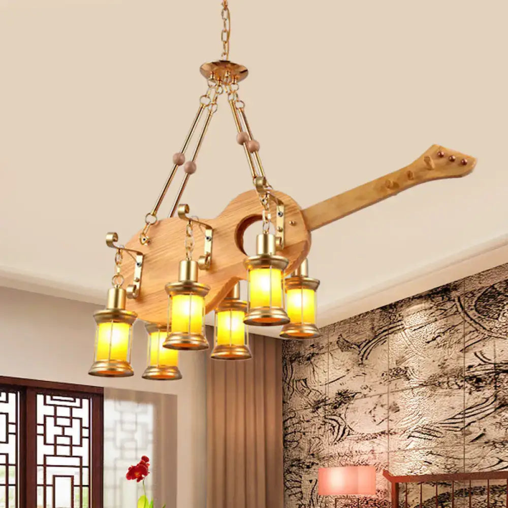 Rustic wooden pendant light with fish guitar design featuring orange glass lanterns and brass accents by decorbites