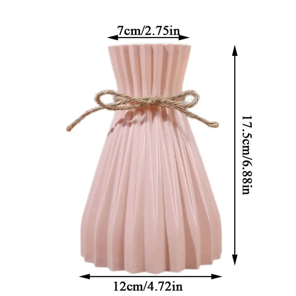 A delicate pink pleated origami style plastic flower vase with a rustic twine bow from decorbites
