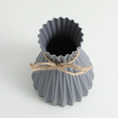 Gray ceramic origami flower vase with fluted scalloped rim and natural twine tied waist by DecorBites™