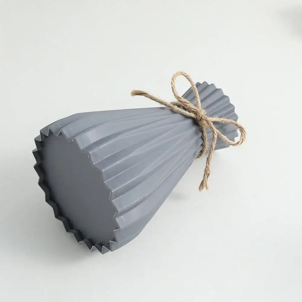 Gray ribbed ceramic origami flower vase tied with natural twine for plastic flower arrangement by DecorBites™
