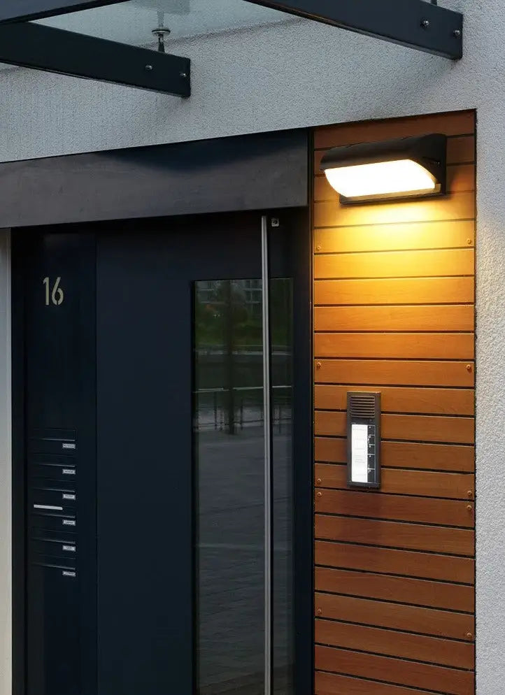 Warm-toned led porch light warm-toned mounted on wooden slat panel for outdoor motion activated use
