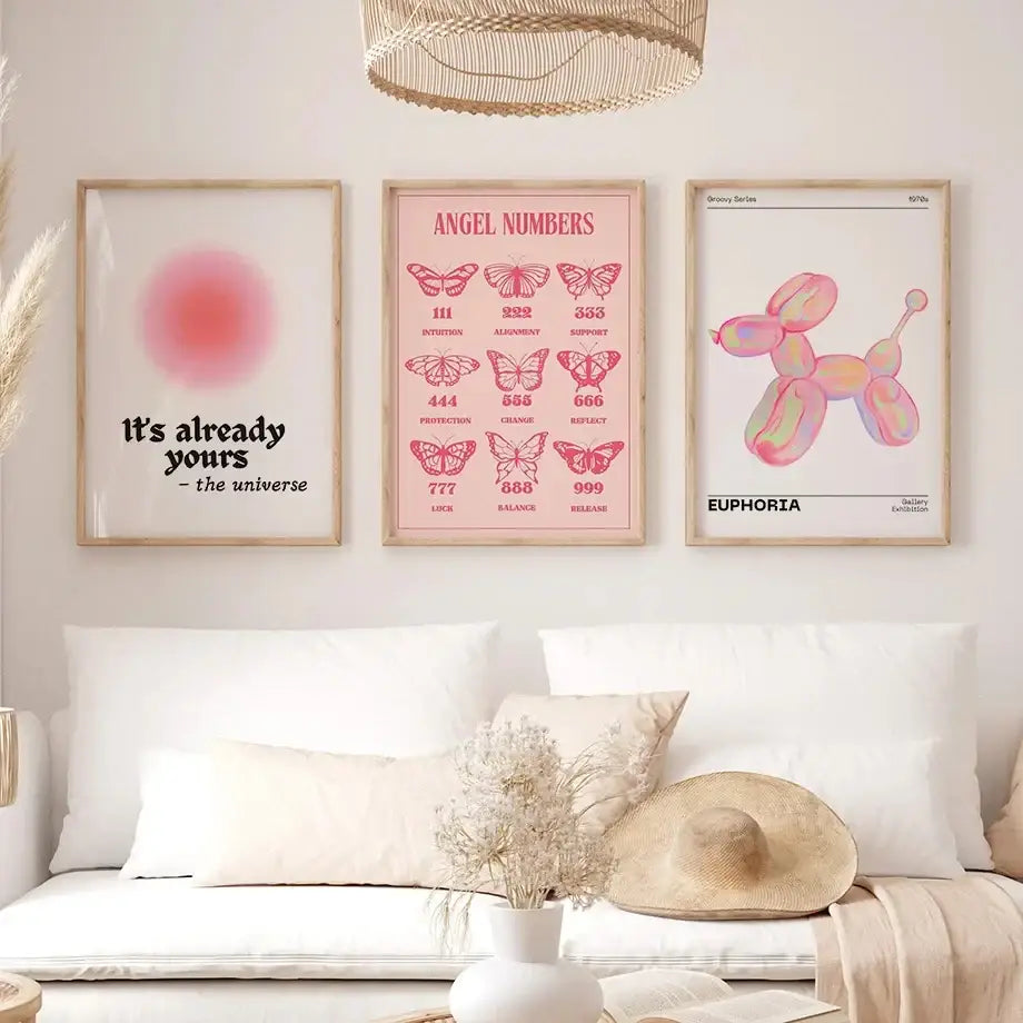 Three framed gallery wall art pieces featuring pink angel number poster, pastel balloon dog, and blurred circle designs