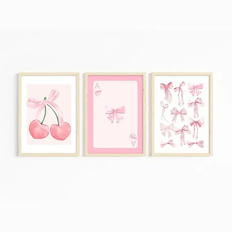 Set of three framed watercolor wall art prints featuring pink bows and cherry designs from decorbites art set