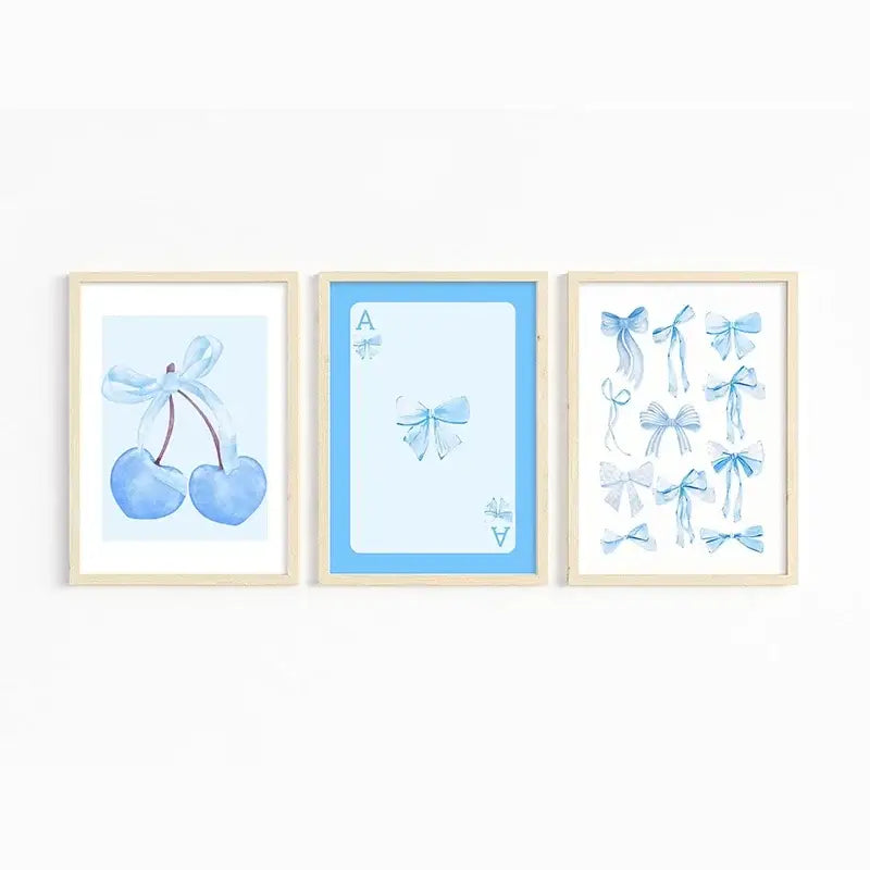 Set of three framed watercolor wall art prints in soft pastel blues featuring blue cherries ace card and pink bows art set
