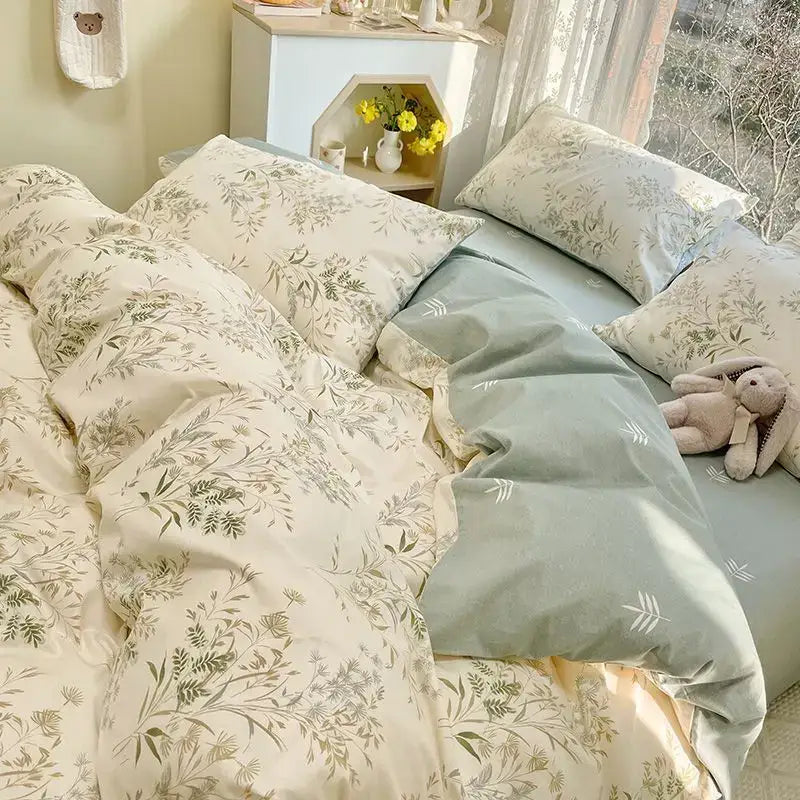 Cream-colored duvet cover set with delicate green botanical prints and soft sage-green cover for pink flowers decorbites