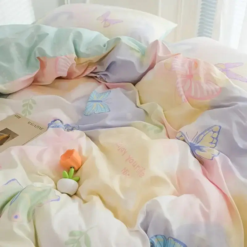Pastel-colored duvet cover set featuring pink flowers and butterfly prints in mint, peach, lavender, and cream hues by decorbites