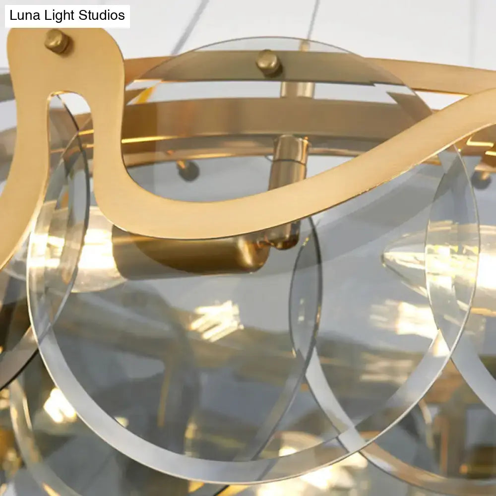 Decorbites postmodern circle pendant light with gold-toned metal and clear glass features a modern sculptural light fixture