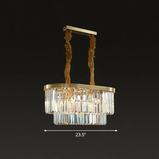 Gold-toned postmodern oblong island light with two tiers of clear crystal rods and sculptural brass chains for dining room