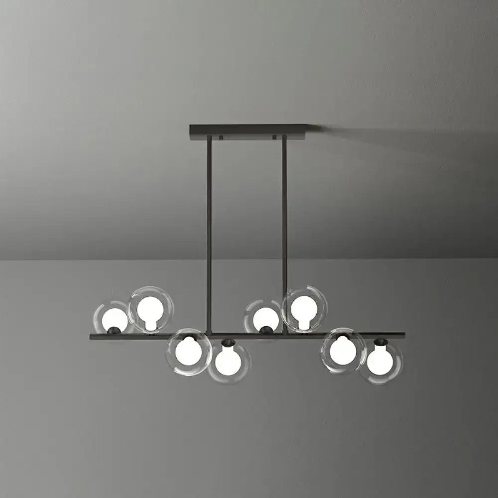 Modern black metal light fixture featuring clear glass spheres with glowing bulbs in decorbites postmodern led island light