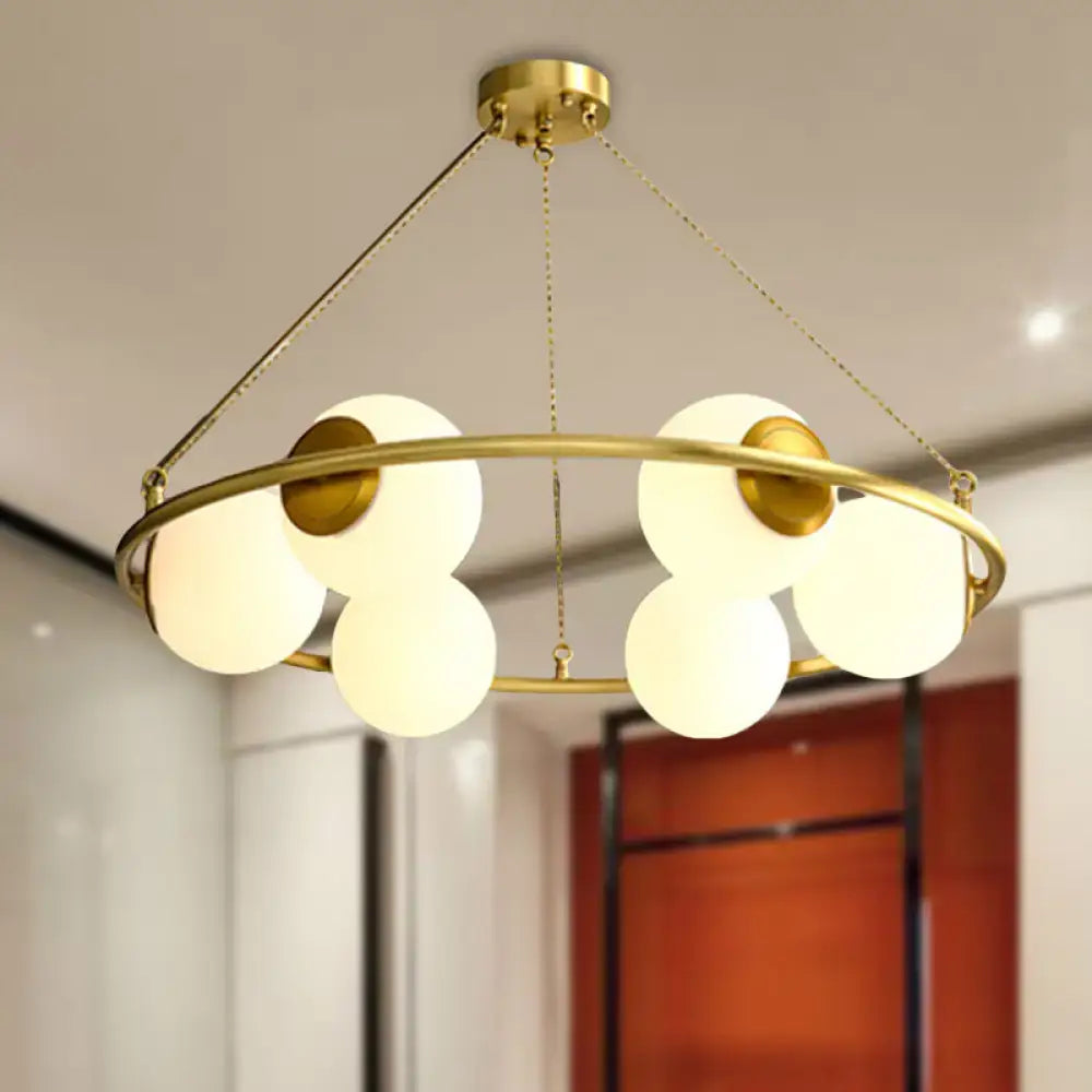 Decorbites postmodern metal chandelier with brass finish circular frame and six frosted glass globe shades