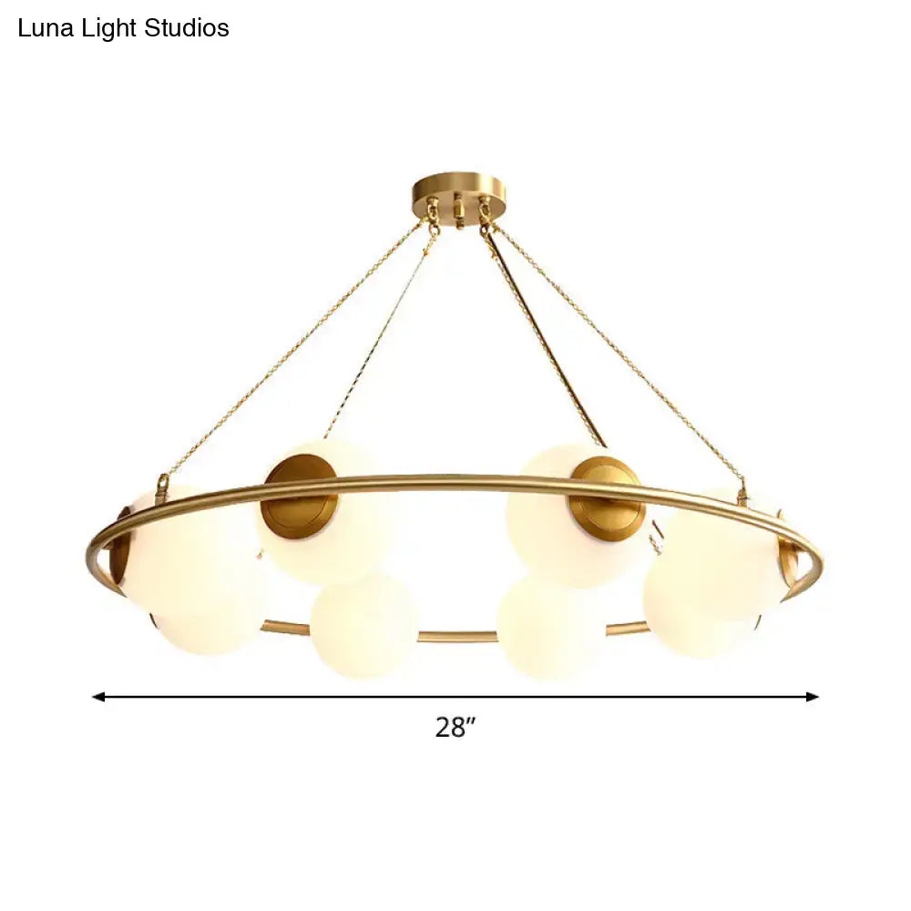 Decorbites™ postmodern circular chandelier light with brass finish and frosted glass globe shades suspended by chains