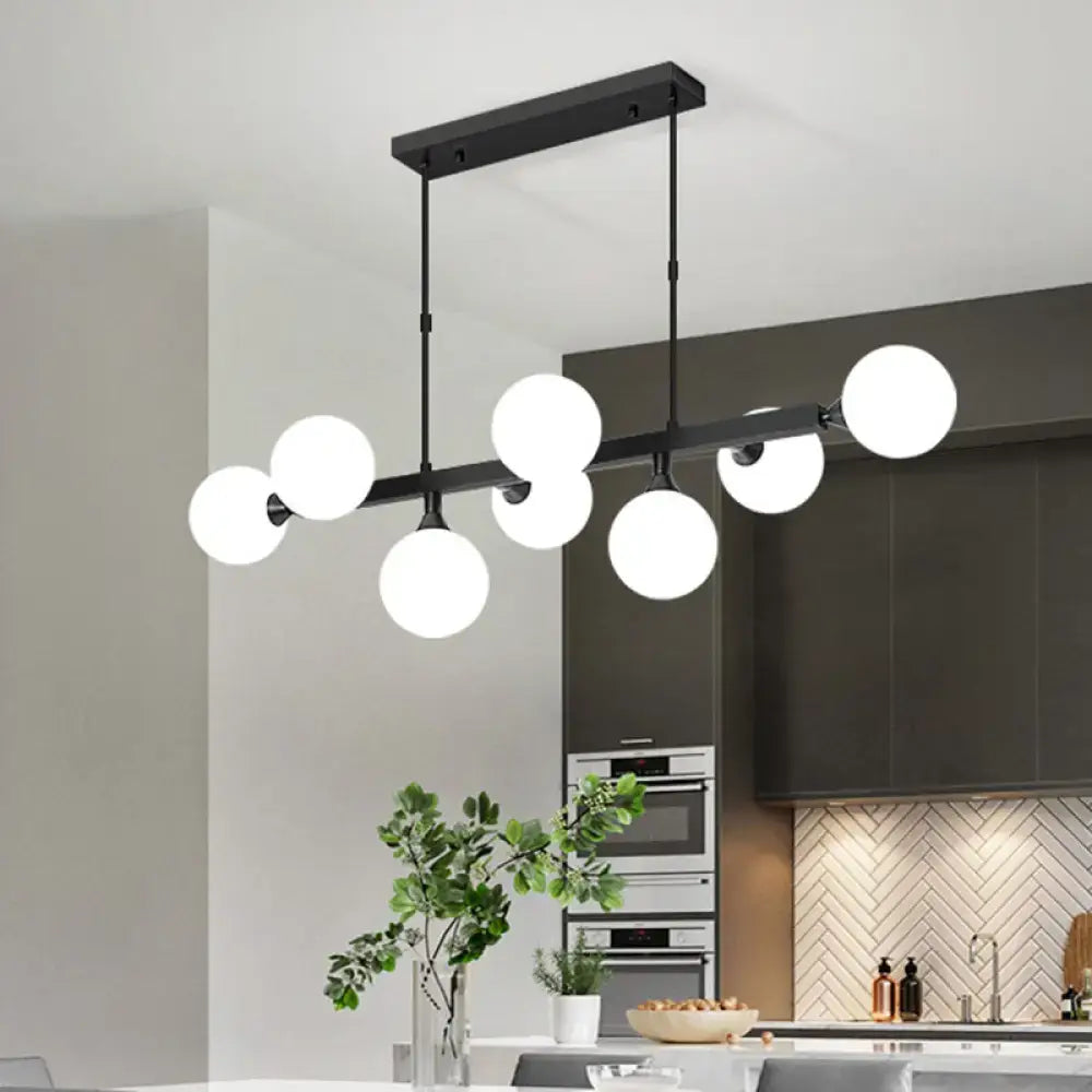Modern black metal dining room pendant light with multiple white opaline glass molecular spherical globes