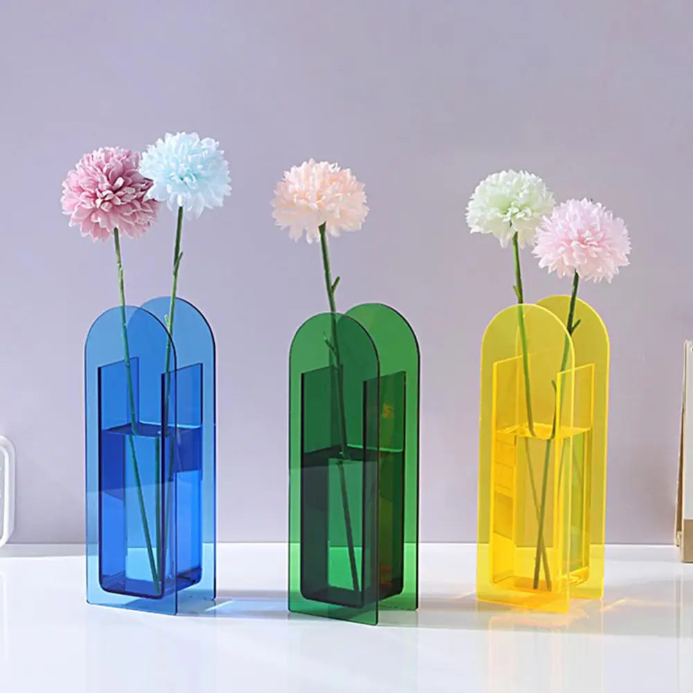 Three translucent acrylic flower vases in rainbow color with modern arched slots in nordic style by DecorBites