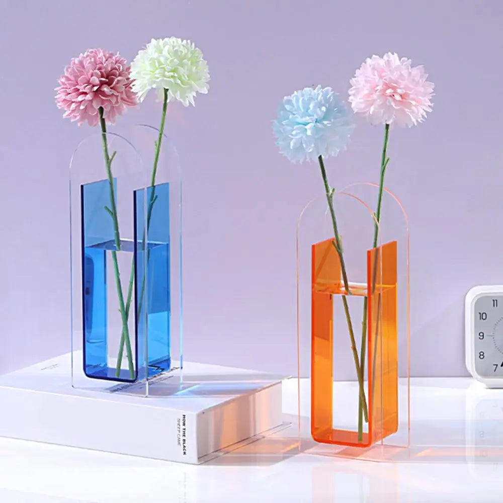 Two translucent acrylic flower vases in vibrant blue and warm orange featuring nordic style and rainbow color accents