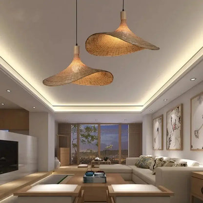 Two elegant light-brown decorbites™ pendant light rattan lamps with dimmable bamboo shades hang from the ceiling
