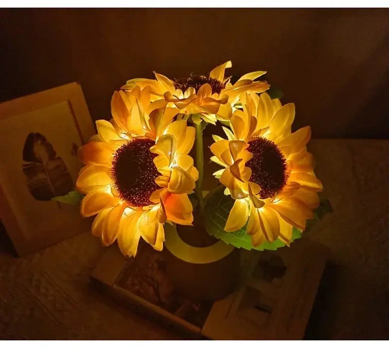A decorbites™ rechargeable sunflower led night light with glowing yellow petals and dark brown centers in a decorative vase