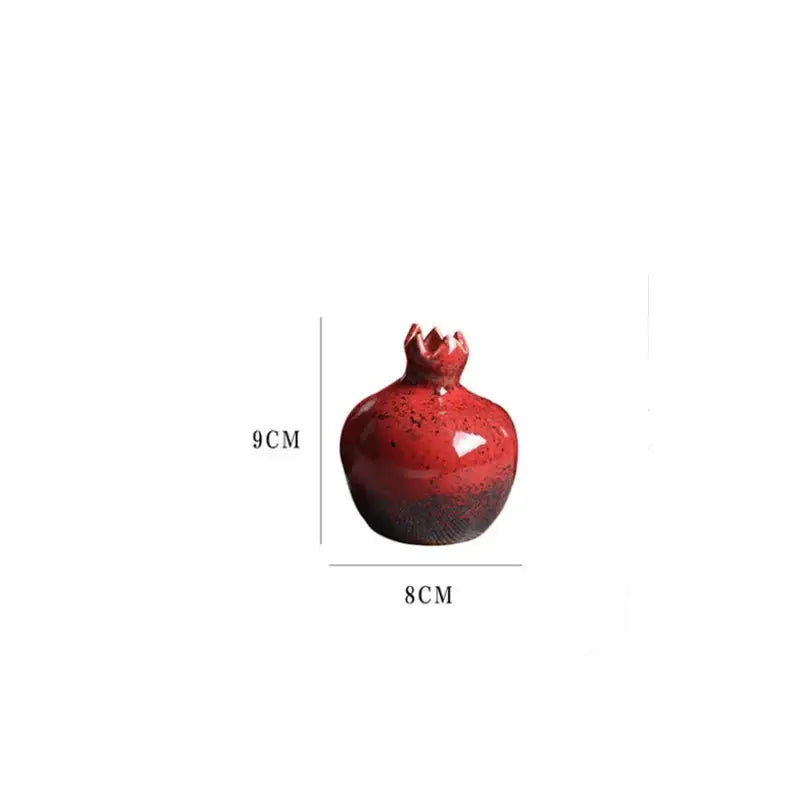 Glossy red pomegranate ceramic vase with darkened base and textured crown for modern home decor by DecorBites