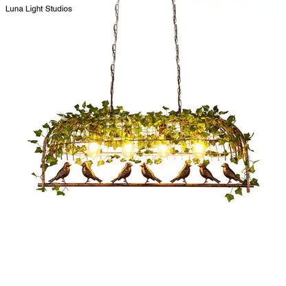 Bronze-colored metal retro birdcage island light fixture with ivy vines and warm glowing bulbs for ceiling use