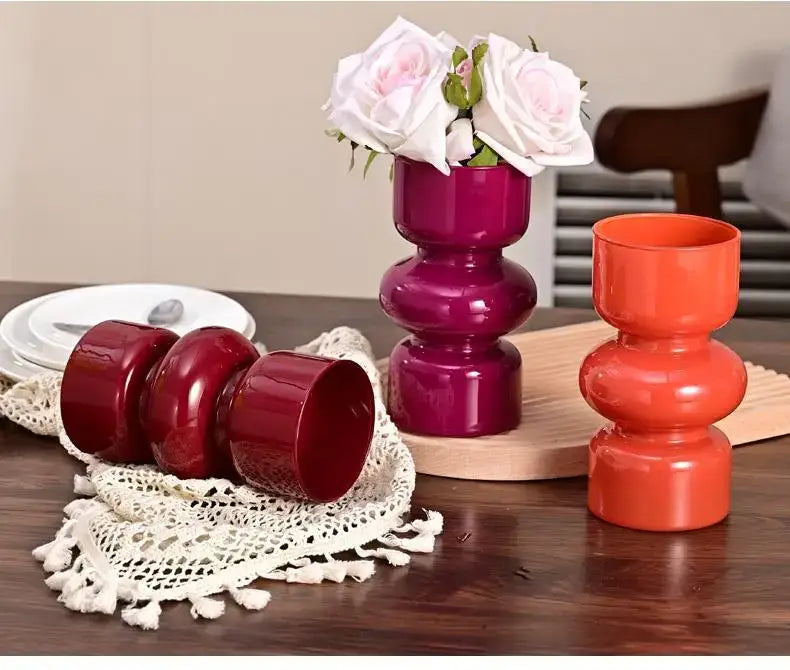 DecorBites™ retro glass vase in vibrant fuchsia ceramic with stacked segments holding delicate white roses