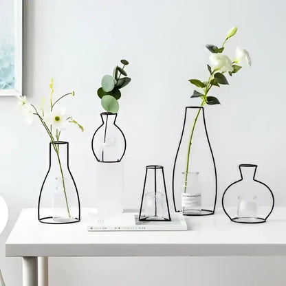 DecorBites™ retro iron flower vase with black metal frame and clear glass interiors holding white and greenery flowers