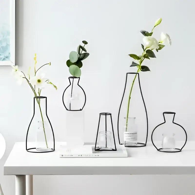 DecorBites™ retro iron flower vase with black metal frame and clear glass interiors holding white and greenery flowers