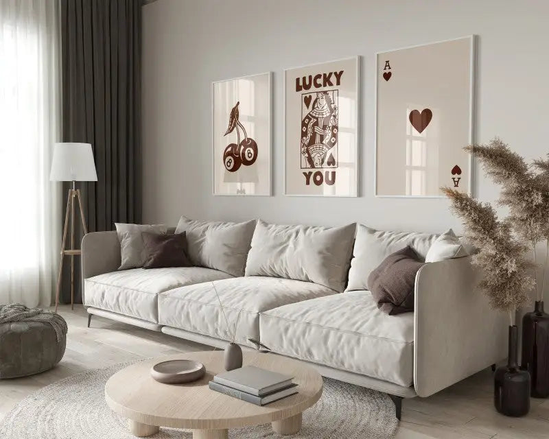 Beige upholstered sectional sofa with dark brown throw pillows paired with decorbites™ retro queen of hearts wall art set featuring ace card wall art