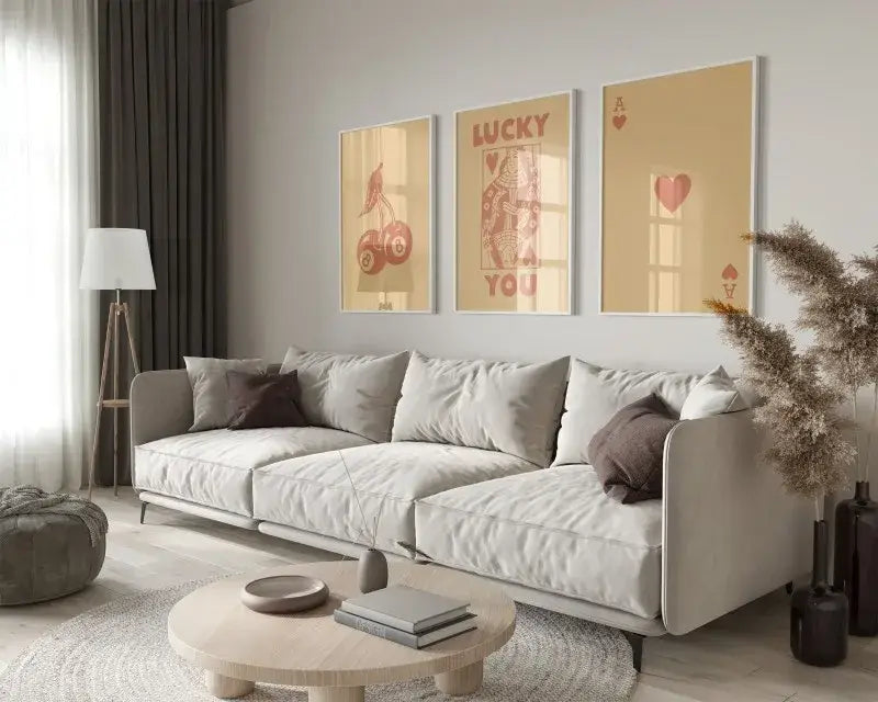 Light gray upholstered sectional sofa with dark brown throw pillows beside decorbites™ retro queen of hearts wall art set