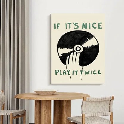 Cream-colored canvas wall art by DecorBites featuring a black and white hand holding vinyl record with green text for modern music play