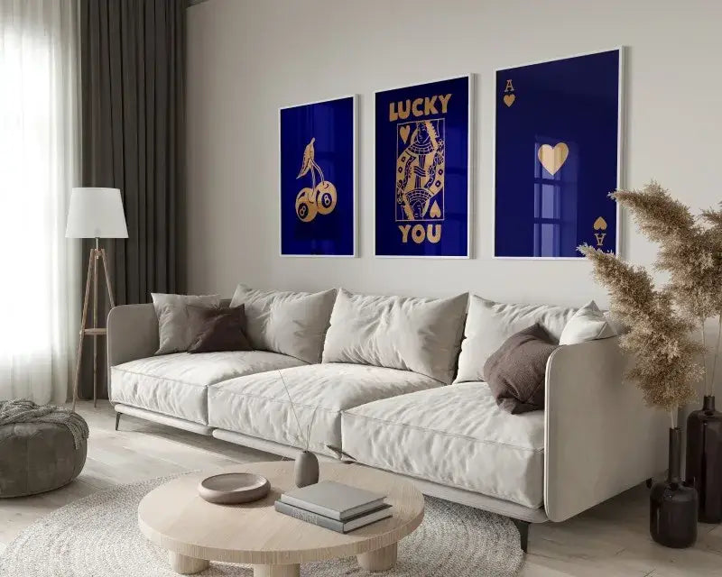 White sectional sofa with beige and brown throw pillows beside DecorBites™ retro set of 3 lucky queen wall art posters