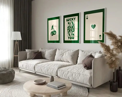 Three framed green and cream retro wall art posters hang above a light gray sofa in the DecorBites™ funky queen-themed set