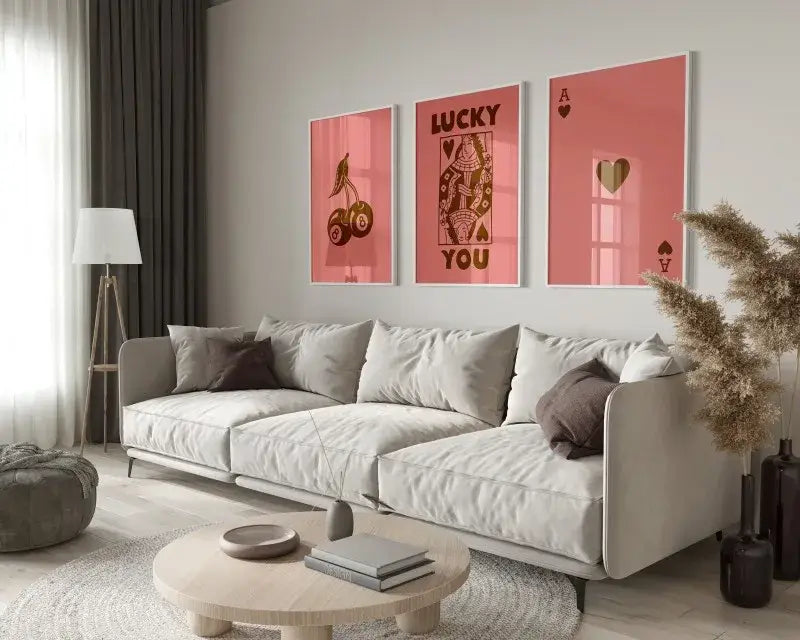 A modern beige sectional sofa with plush cushions and dark gray throw pillows near decorbites™ retro wall art posters set queen of hearts