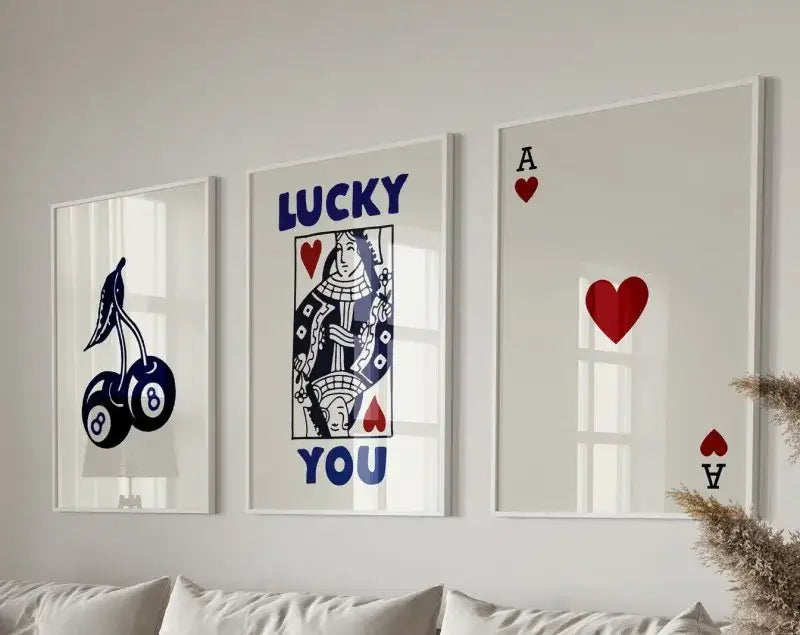 Set of three framed decorbites™ retro wall art prints featuring queen of hearts and cherry motifs in navy blue red and white