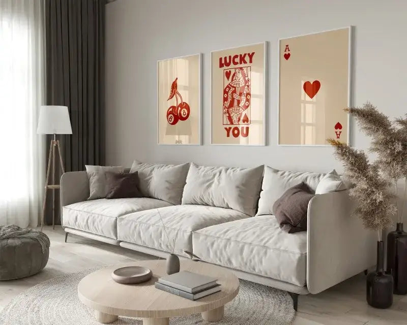 Light gray upholstered sectional sofa with dark brown throw pillows in a room featuring decorbites retro wall art set queen of hearts theme