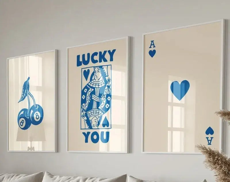 Three framed retro wall art pieces featuring blue playing card designs on a cream background by DecorBites™