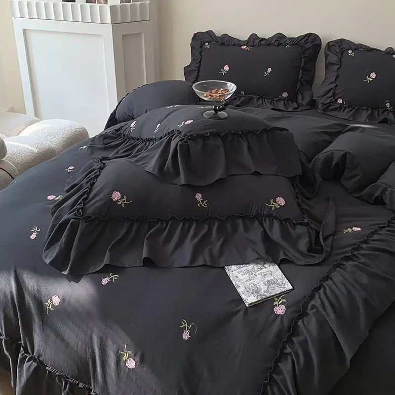 DecorBites™ rose embroidered duvet cover set in black satin with pink floral embroidery and layered ruffled edges