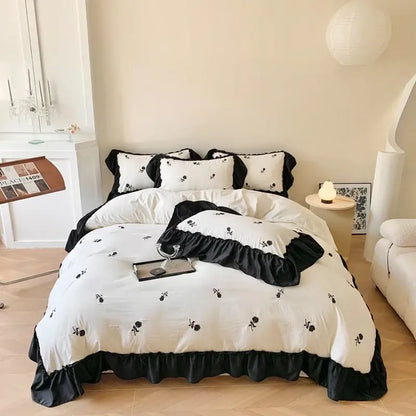 Decorbites™ rose embroidered duvet cover set featuring black and white floral embroidery with ruffled edges