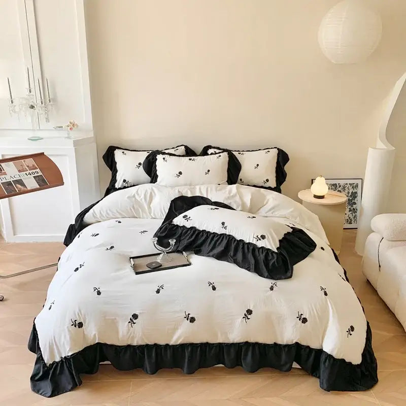 Decorbites™ rose embroidered duvet cover set featuring black and white floral embroidery with ruffled edges