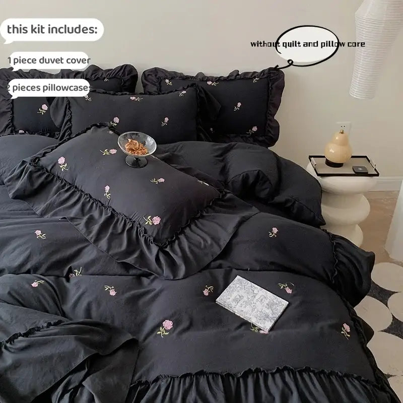 Black satin duvet cover set with delicate pink rose embroidery and ruffled edges from decorbites princess style