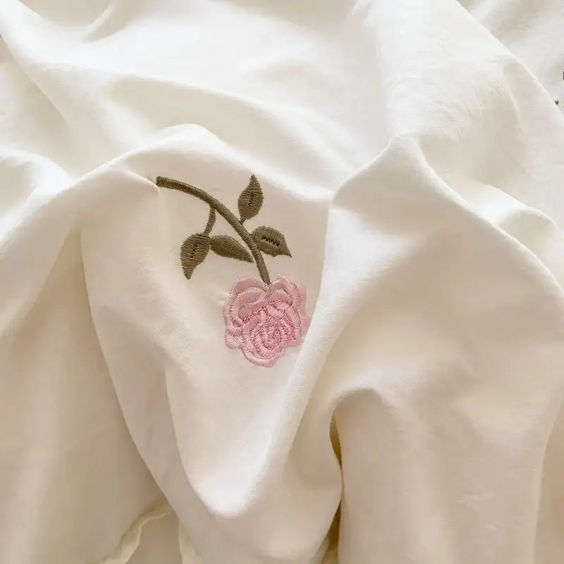 Delicate pink rose embroidered duvet cover set with green stem on soft white fabric by DecorBites princess style