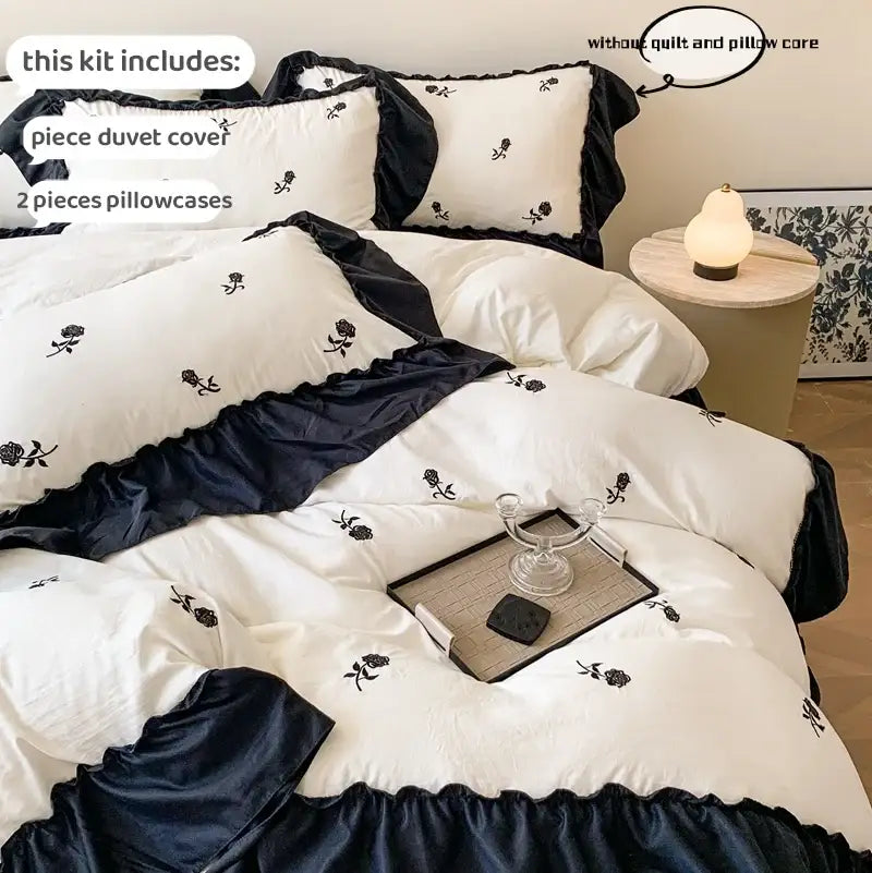 DecorBites™ rose embroidered duvet cover set in white and navy blue with black rose embroidery and ruffled edges