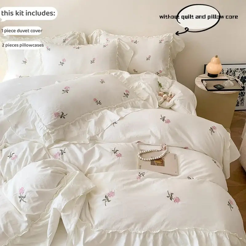 White floral rose embroidered duvet cover set with ruffled edges and matching pillowcases by decorbites
