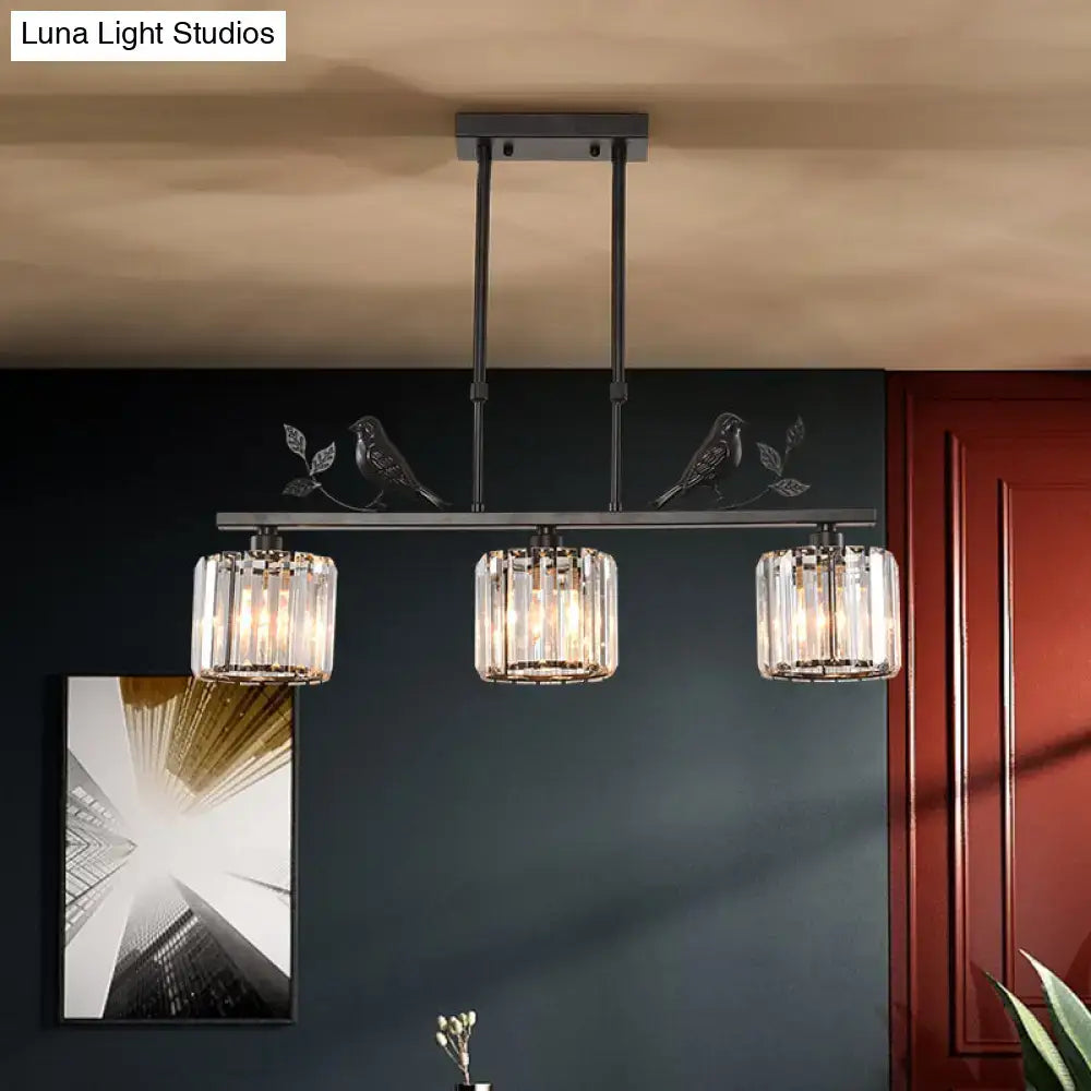 Black metal pendant light with three cylindrical crystal bulbs and decorative bird motifs for dining room crystal island lighting