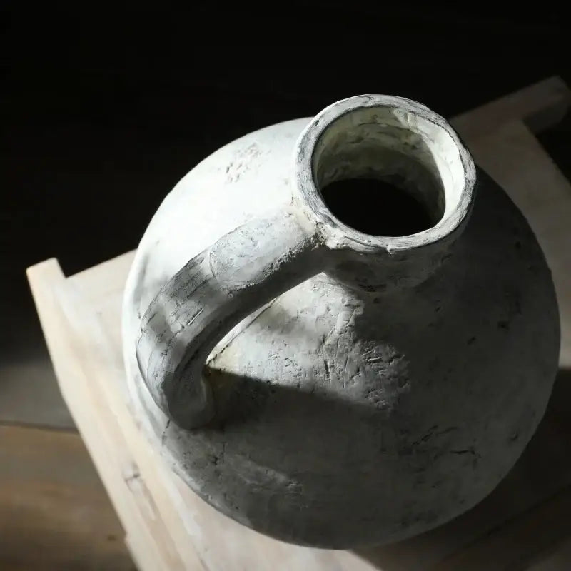 Decorbites rustic handmade ceramic vase in matte gray coarse pottery with rounded body and single curved handle for home decor