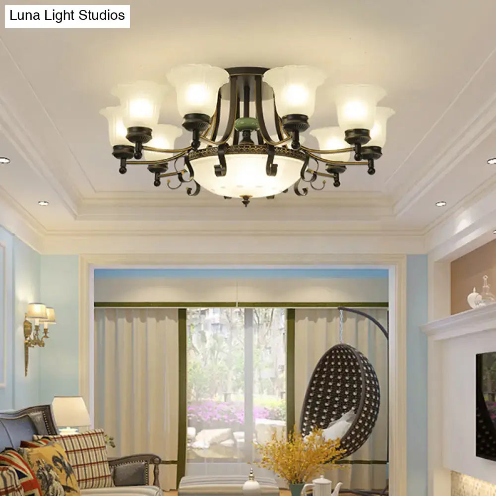Antique bronze-finished ceiling light fixture with eight frosted glass shades and ornate central diffuser for living room