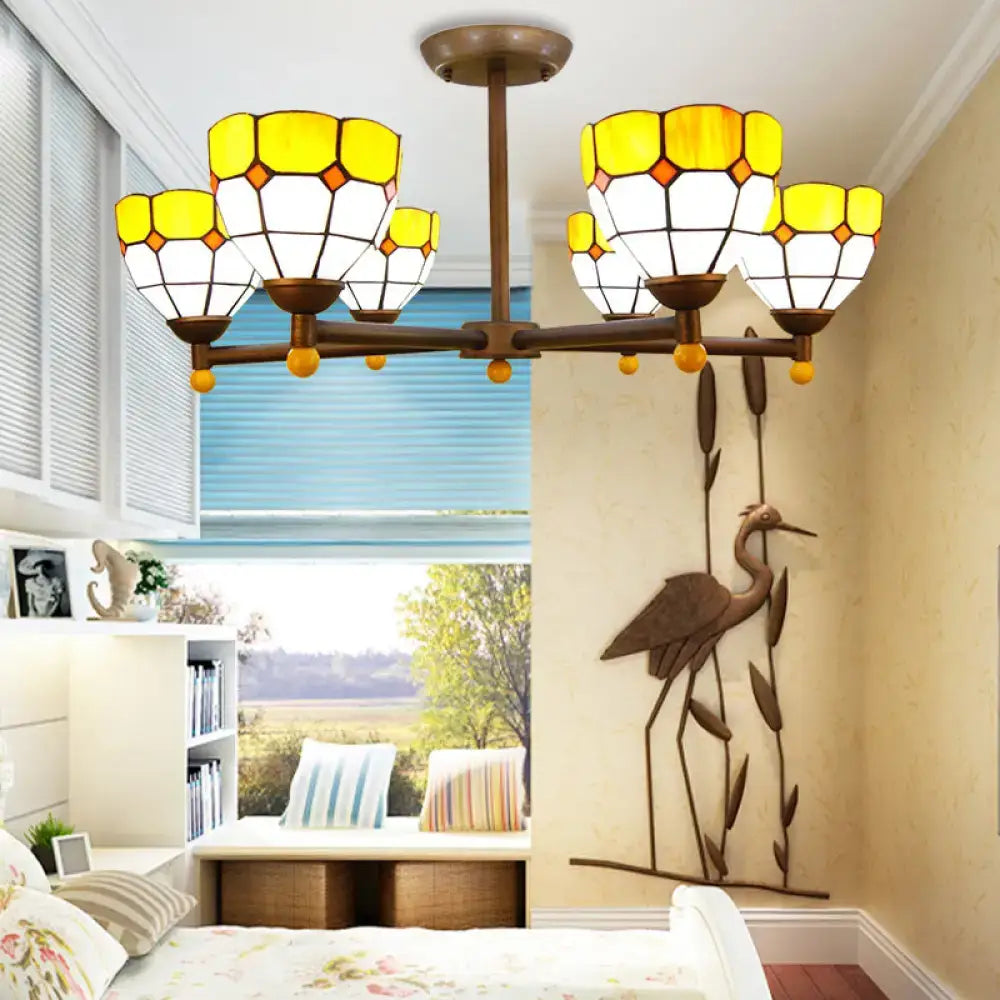 Brass-toned rustic style chandelier light with yellow and white stained glass shades for dining room lighting
